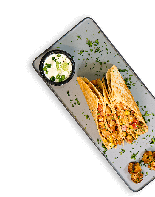 Tacos and appetizers on a modern serving plate